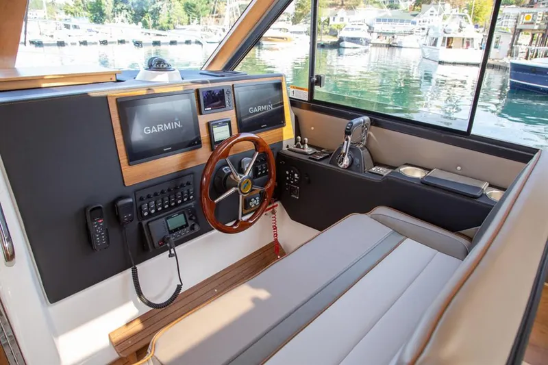 Slide: The Image of Manufacturer Provided Image: 2020 Cutwater C-32 C helm with Garmin navigation, leather seating, and waterfront view. - 9