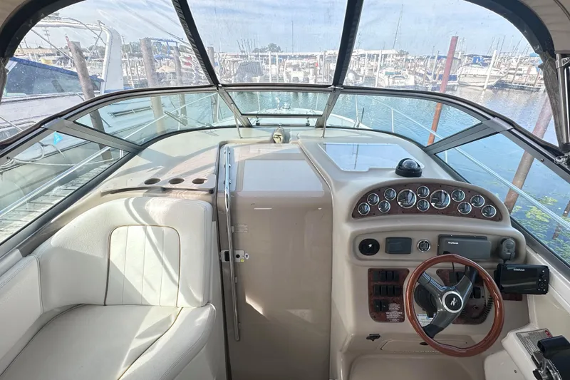 Slide: The Image of Interior view of 2000 Sea Ray 290 Sundancer boat cockpit with steering wheel and dashboard. - 10