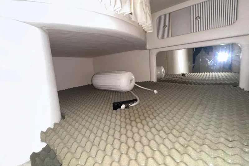 Slide: The Image of Interior cabin of 2000 Sea Ray 290 Sundancer with storage and cushion flooring. - 20