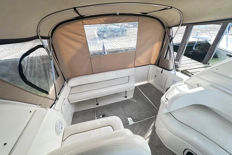 Slide: The Image of 2000 Sea Ray 290 Sundancer boat interior with beige seating and canopy. - 4