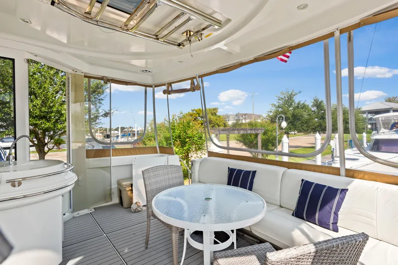 Slide: The Image of Luxurious 2005 Carver 466 Motor Yacht interior with seating and table, docked at marina. - 11