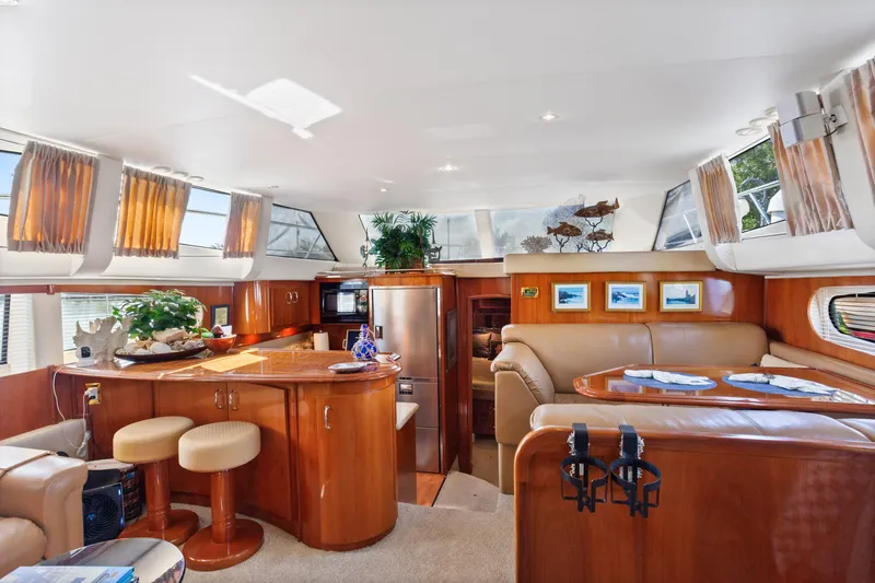 Slide: The Image of Luxurious interior of 2005 Carver 466 Motor Yacht with elegant wood finishes and seating. - 16