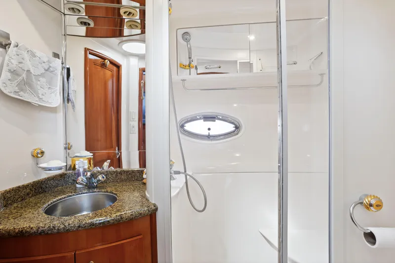 Slide: The Image of Luxurious bathroom in 2005 Carver 466 Motor Yacht with granite countertop and shower. - 24