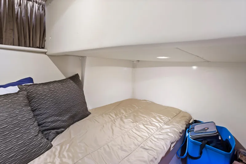 Slide: The Image of Cozy cabin interior of 2005 Carver 466 Motor Yacht with bed and storage. - 27