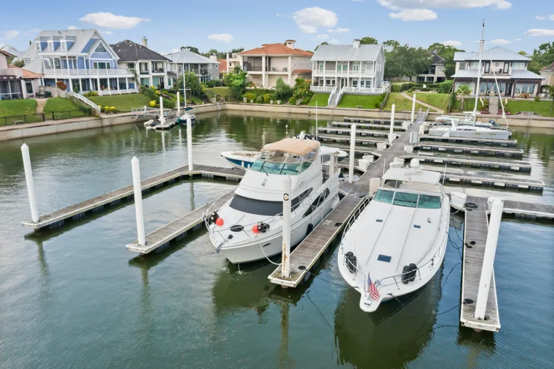 Slide: The Image of 2005 Carver 466 Motor Yacht docked in a scenic marina with waterfront homes. - 4