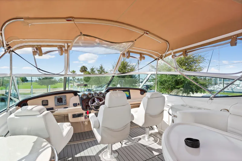 Slide: The Image of 2005 Carver 466 Motor Yacht helm with luxurious seating and panoramic views. - 6