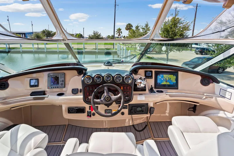 Slide: The Image of 2005 Carver 466 Motor Yacht helm with navigation screens and steering wheel. - 7