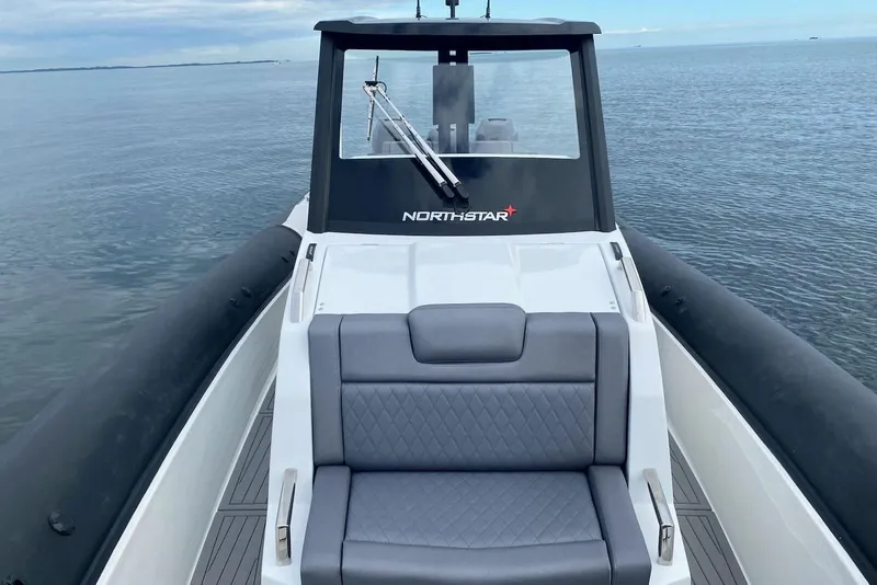 Slide: The Image of 2026 Northstar ION 12 boat on calm water, featuring sleek design and comfortable seating. - 10