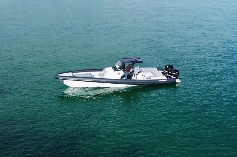 Slide: The Image of 2026 Northstar ION 12 boat cruising on calm, clear blue water. - 15