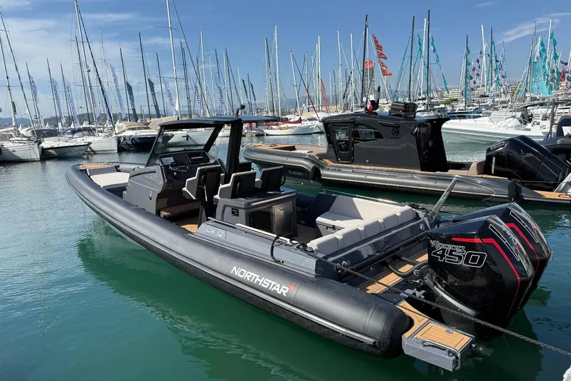 Slide: The Image of 2026 Northstar ION 12 boat docked in marina, featuring powerful outboard engine. - 16