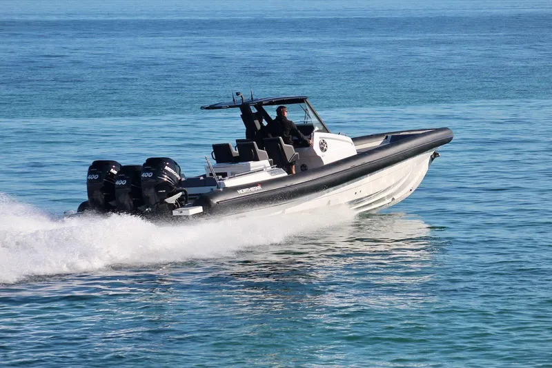 Slide: The Image of 2026 Northstar ION 12 boat cruising on clear blue water, powered by triple engines. - 2