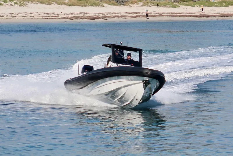 Slide: The Image of 2026 Northstar ION 12 boat speeding on water near sandy beach. - 4