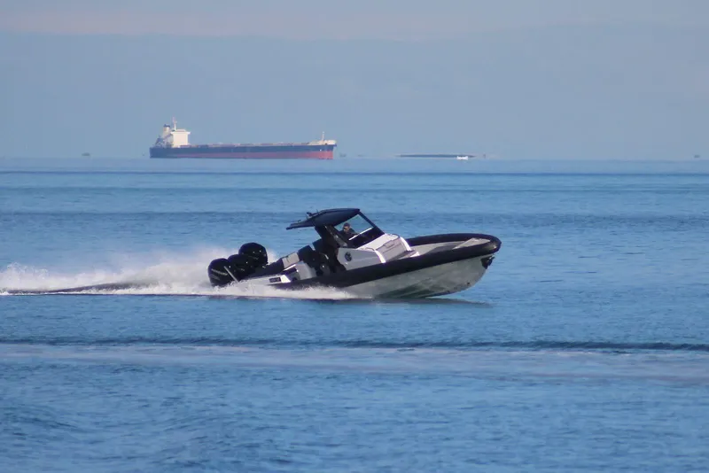 Slide: The Image of 2026 Northstar ION 12 speedboat cruising on open water with cargo ship in background. - 5