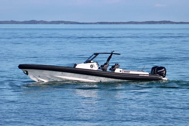 Slide: The Image of 2026 Northstar ION 12 boat cruising on calm blue waters. - 8