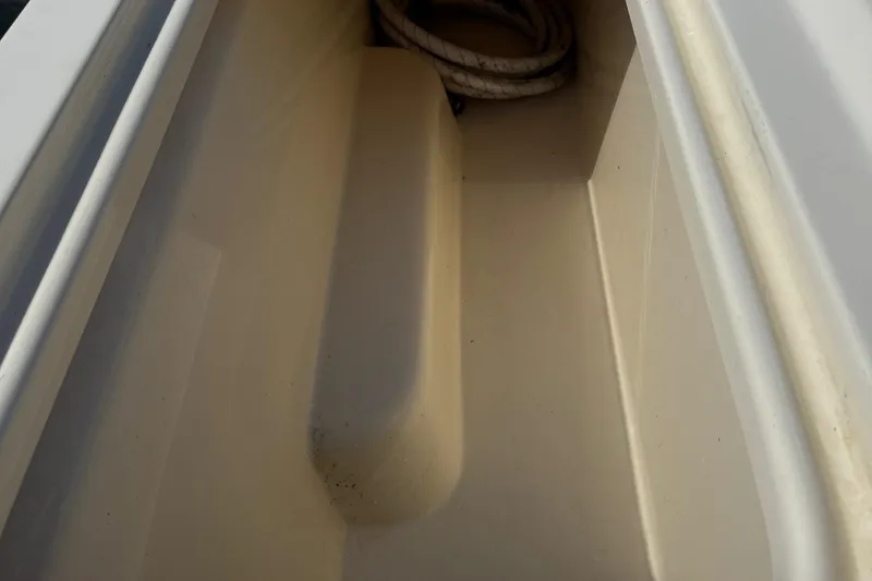 Slide: The Image of Storage compartment of 2011 Parker 2510 XL Walkaround boat with coiled rope. - 16