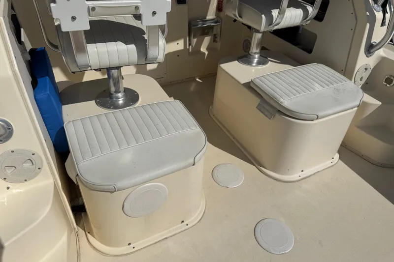 Slide: The Image of 2011 Parker 2510 XL Walkaround boat interior with cushioned seating and storage compartments. - 4