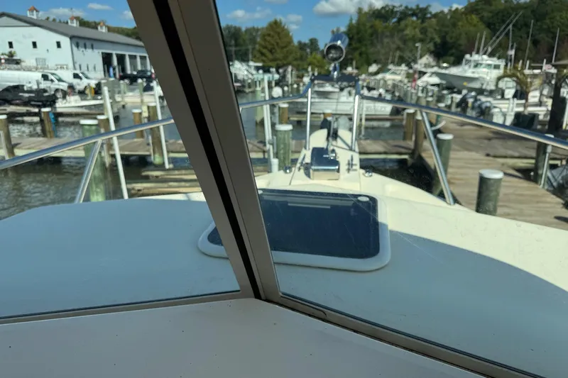 Slide: The Image of 2011 Parker 2510 XL Walkaround boat docked at a marina, view from the cabin. - 5