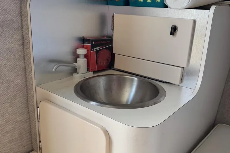 Slide: The Image of Compact sink area in 2011 Parker 2510 XL Walkaround boat interior. - 6