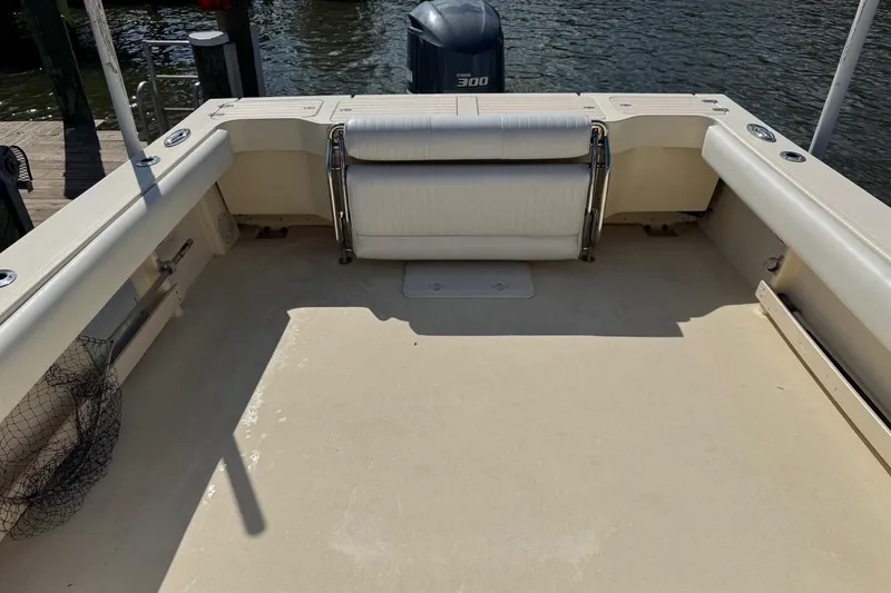 Slide: The Image of 2011 Parker 2510 XL Walkaround boat deck with seating and outboard motor. - 7