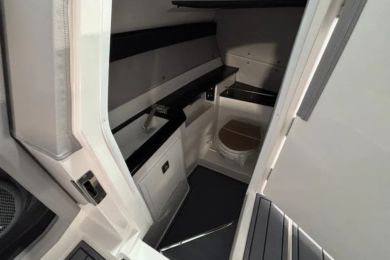 Slide: The Image of Interior of 2026 Cobalt R33 boat featuring compact bathroom and sleek design. - 22