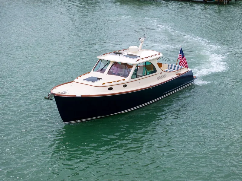 Slide: The Image of 2019 Hinckley Picnic Boat 34 cruising on water with American flag. - 11