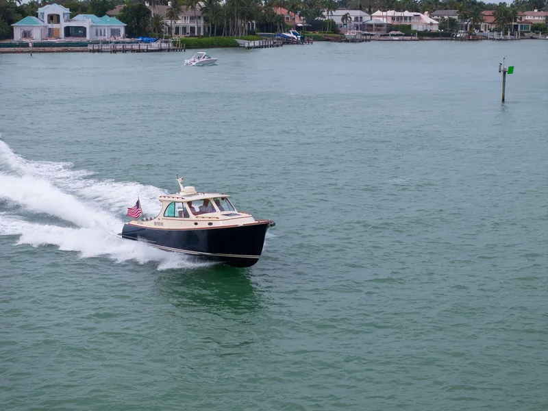Slide: The Image of 2019 Hinckley Picnic Boat 34 cruising on a calm waterway. - 12