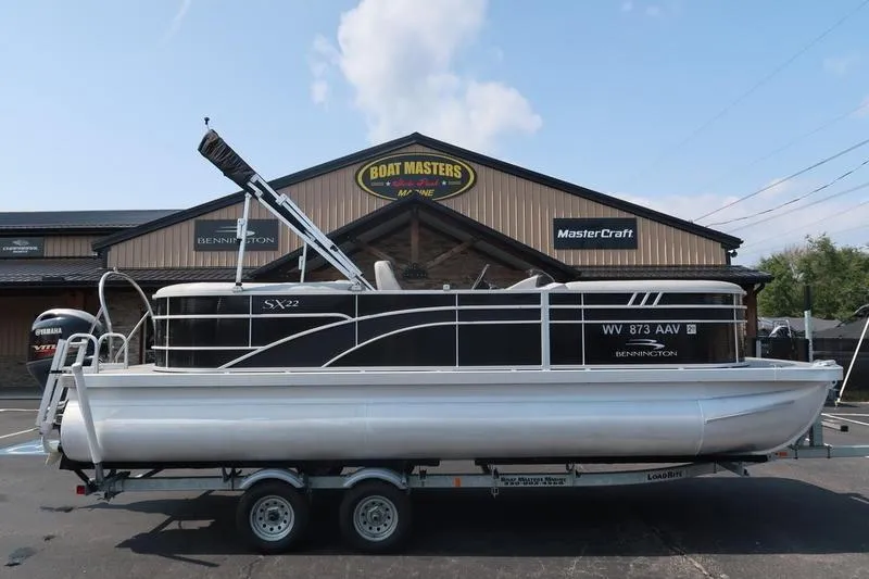 The Image of 2023 Bennington 22 SXSR pontoon boat on trailer at dealership. - 0