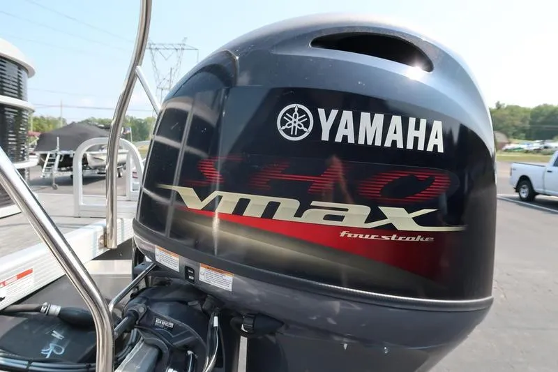 Slide: The Image of Yamaha VMAX outboard motor on 2023 Bennington 22 SXSR boat, parked outdoors. - 10