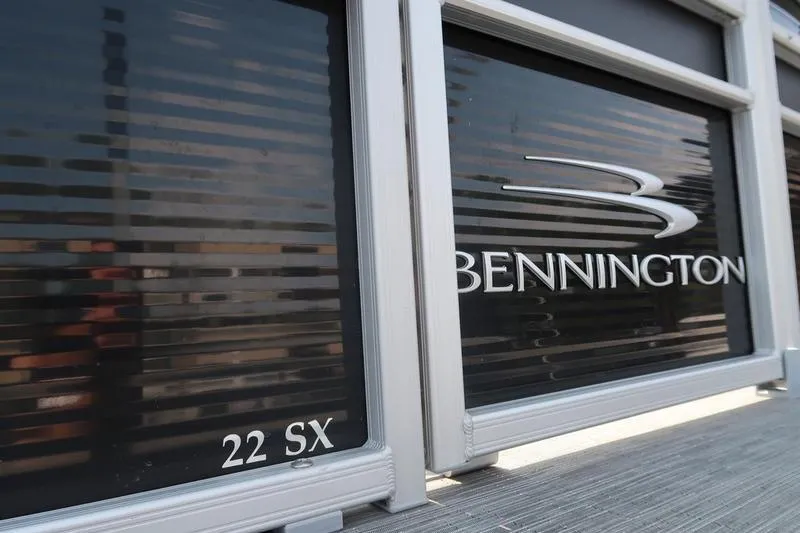 Slide: The Image of 2023 Bennington 22 SXSR boat with sleek design and branding details. - 13