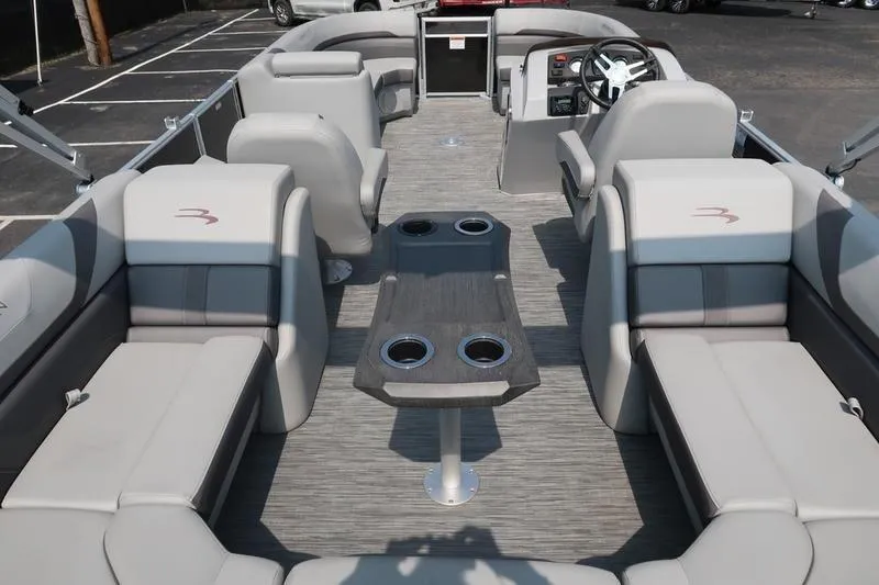 Slide: The Image of 2023 Bennington 22 SXSR pontoon boat interior with gray seating and central table. - 19