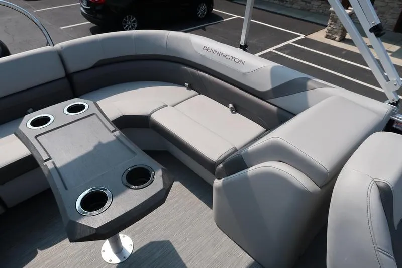 Slide: The Image of 2023 Bennington 22 SXSR pontoon boat interior with gray seating and cup holders. - 22
