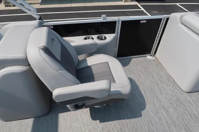 Slide: The Image of 2023 Bennington 22 SXSR boat interior with gray captain's chair and cup holders. - 27