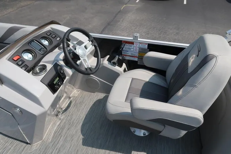 Slide: The Image of 2023 Bennington 22 SXSR boat interior with steering wheel and captain's chair. - 28