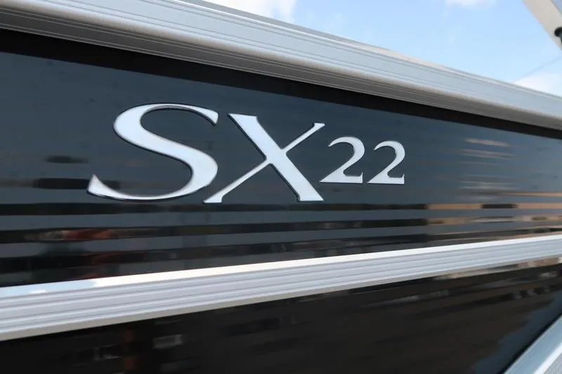 Slide: The Image of Close-up of 2023 Bennington 22 SXSR boat model name on black exterior. - 6