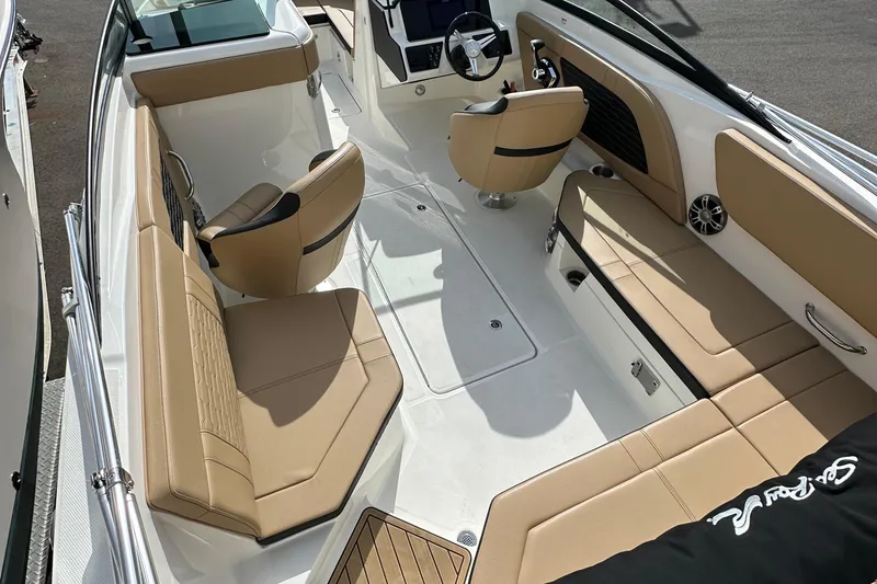 Slide: The Image of 2023 Sea Ray SPX 230 Outboard interior with tan seating and modern design. - 5