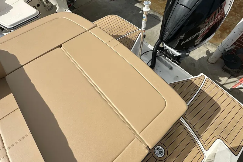 Slide: The Image of 2023 Sea Ray SPX 230 Outboard boat with tan seating and wood-patterned deck. - 6