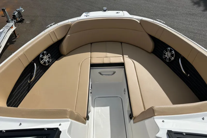 Slide: The Image of 2023 Sea Ray SPX 230 Outboard boat interior with tan seating and speakers. - 8