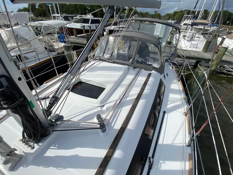 Slide: The Image of 2014 Beneteau Oceanis 34 sailboat docked at marina, showcasing deck and rigging. - 26