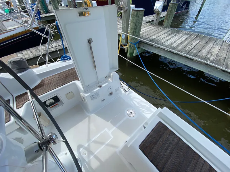 Slide: The Image of 2014 Beneteau Oceanis 34 sailboat cockpit with open storage, docked at marina. - 35