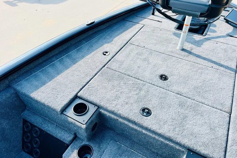 Slide: The Image of 2026 Tracker Pro Team 195 boat interior with carpeted deck and seating. - 12