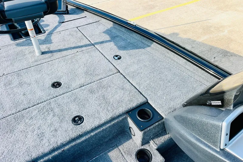 Slide: The Image of 2026 Tracker Pro Team 195 boat interior with gray carpet and seating. - 13