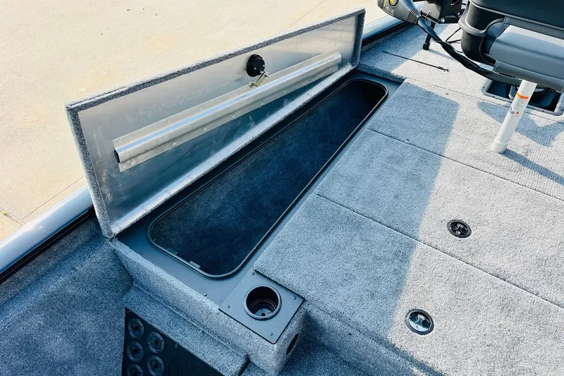 Slide: The Image of 2026 Tracker Pro Team 195 boat interior with open storage compartment and seating. - 14