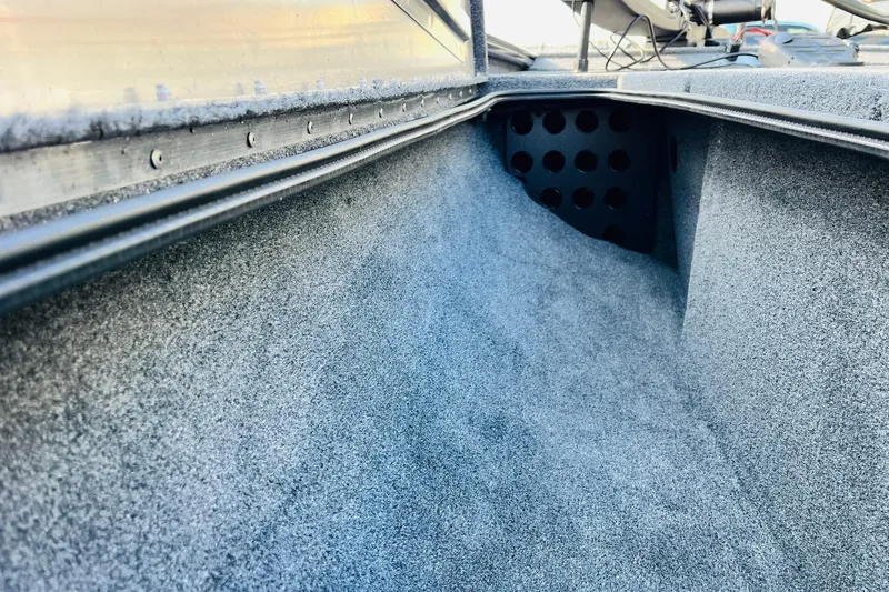 Slide: The Image of Interior view of 2026 Tracker Pro Team 195 boat, showcasing carpeted storage area. - 15