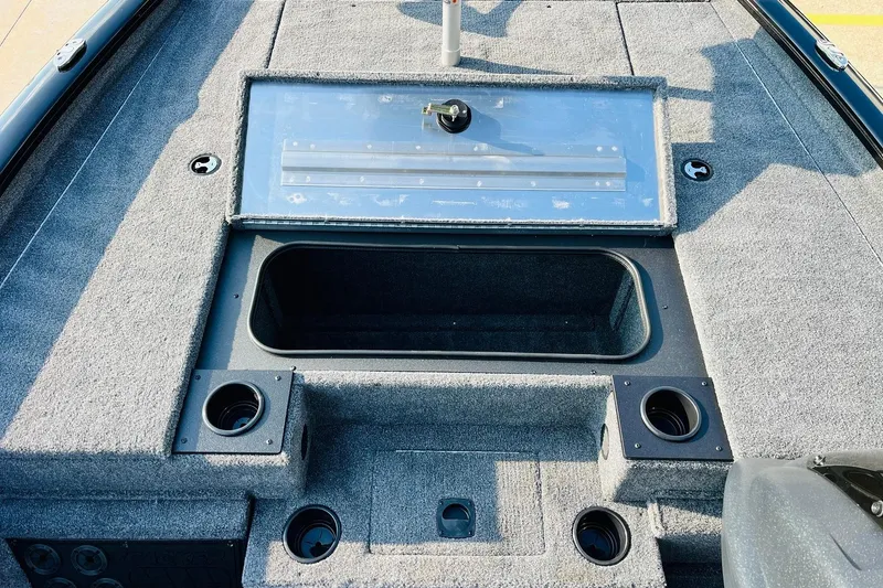 Slide: The Image of 2026 Tracker Pro Team 195 boat interior with storage compartments and cup holders. - 17