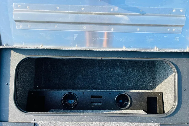 Slide: The Image of Storage compartment in 2026 Tracker Pro Team 195 boat, featuring dual speakers. - 18