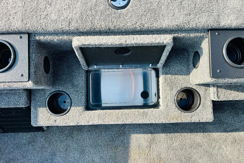 Slide: The Image of Interior of 2026 Tracker Pro Team 195 boat with cup holders and storage compartments. - 23