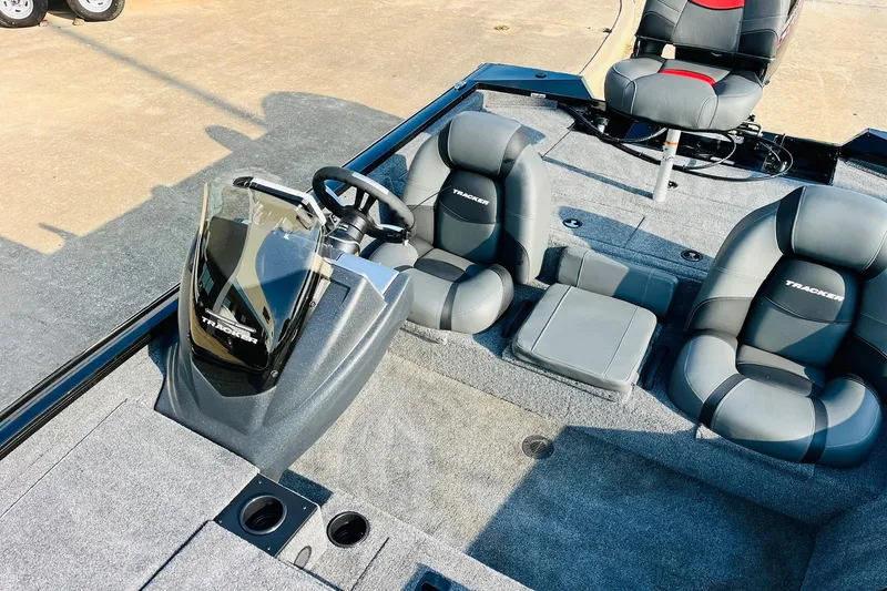 Slide: The Image of 2026 Tracker Pro Team 195 boat interior with steering console and cushioned seats. - 25