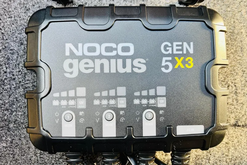 Slide: The Image of NOCO Genius GEN 5X3 battery charger on Tracker Pro Team 195, 2026 model. - 27