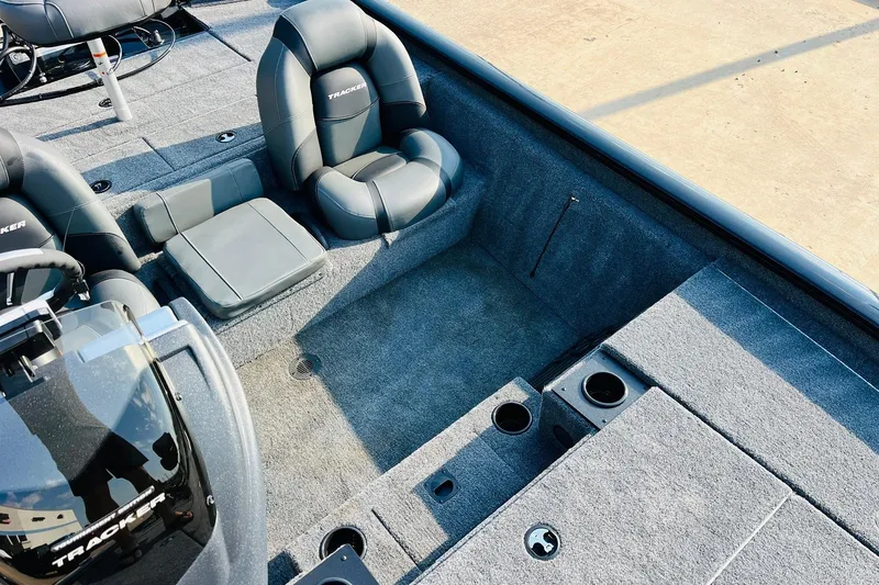 Slide: The Image of 2026 Tracker Pro Team 195 boat interior with gray seating and carpeted flooring. - 28