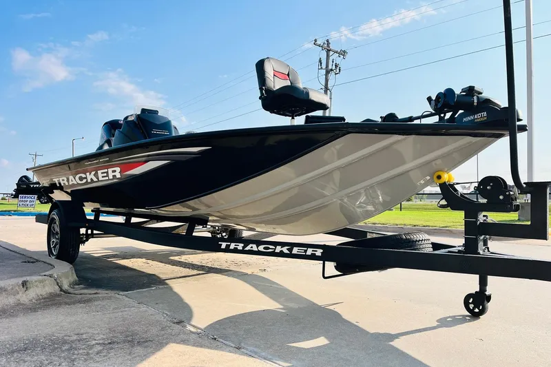 Slide: The Image of 2026 Tracker Pro Team 195 boat on trailer, parked outdoors under clear sky. - 3